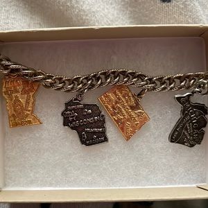 Charm bracelet with charms from North Dakota, Michigan, Wisco, and Minnesota.